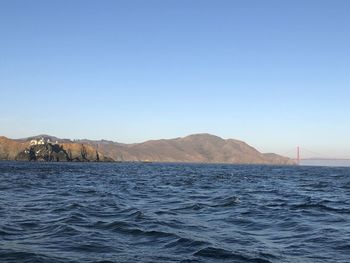 Scenic view of sea against clear blue sky