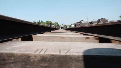 Surface level of railroad tracks against clear sky