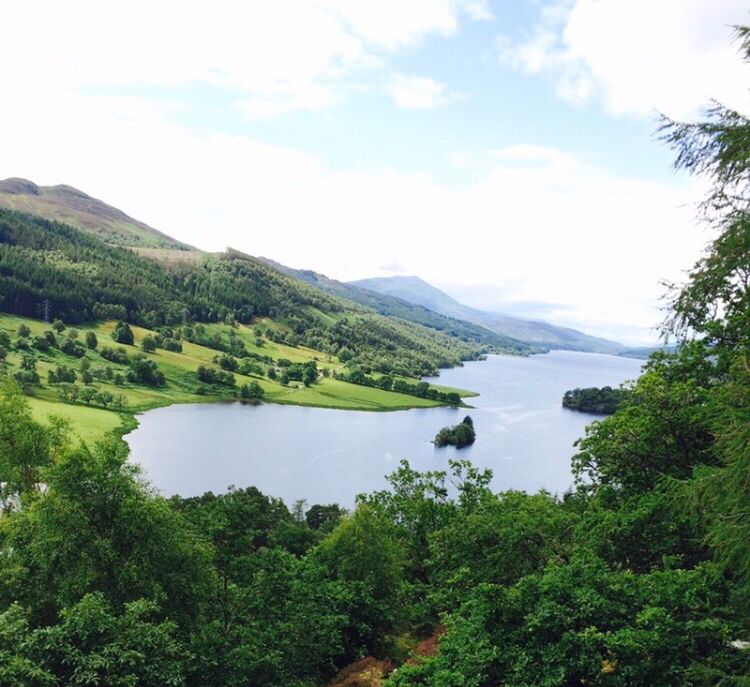 SCENIC VIEW OF GREEN LANDSCAPE AND MOUNTAINS