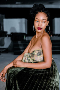 Portrait of young woman sitting outdoors