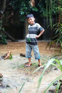 Full length of boy standing in water