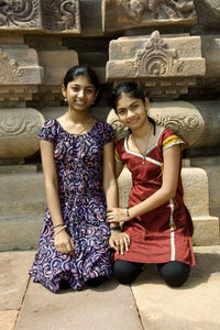 Portrait of smiling young couple sitting outdoors