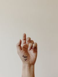Close-up of hand against white background