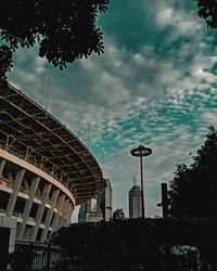 Low angle view of buildings against cloudy sky