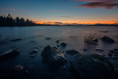 Scenic view of lake against sky during sunset