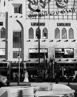 People on street by buildings in city