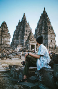 Man sitting against old temple