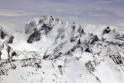 Low angle view of snowcapped landscape against sky