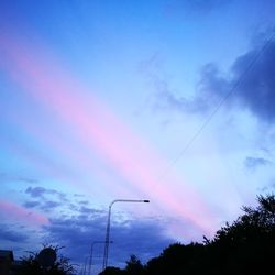 Low angle view of silhouette trees against sky