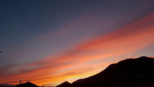 Scenic view of silhouette mountains against sky during sunset