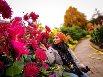 Woman standing on pink flowering plants