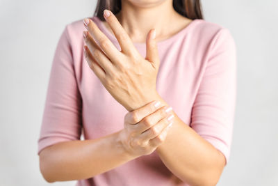 Midsection of woman holding hands