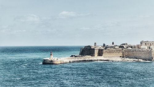 Scenic view of sea and buildings against sky