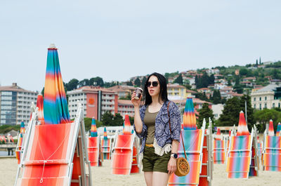 Lifestyle portrait. beautiful asian woman relaxing in sunny day at beach. summer. sea. travel