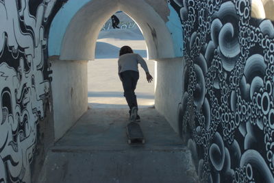 Rear view of man walking in building