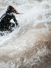 Blurred motion of person splashing water