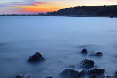 Reflection of clouds in water at sunset