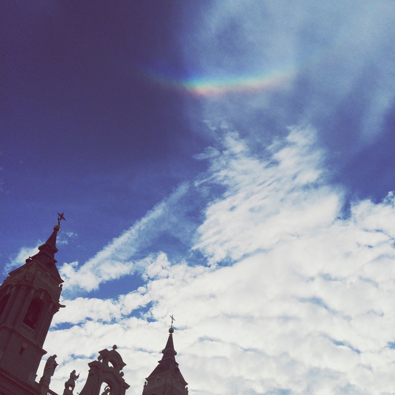 low angle view, architecture, sky, built structure, building exterior, cloud - sky, place of worship, religion, high section, blue, spirituality, cloudy, famous place, cloud, travel destinations, international landmark, church, travel, outdoors