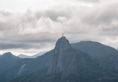 Scenic view of mountains against cloudy sky