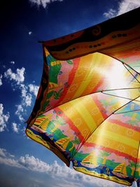 Low angle view of multi colored umbrella against sky