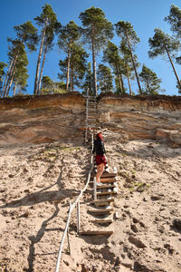 Woman standing on steps at beach