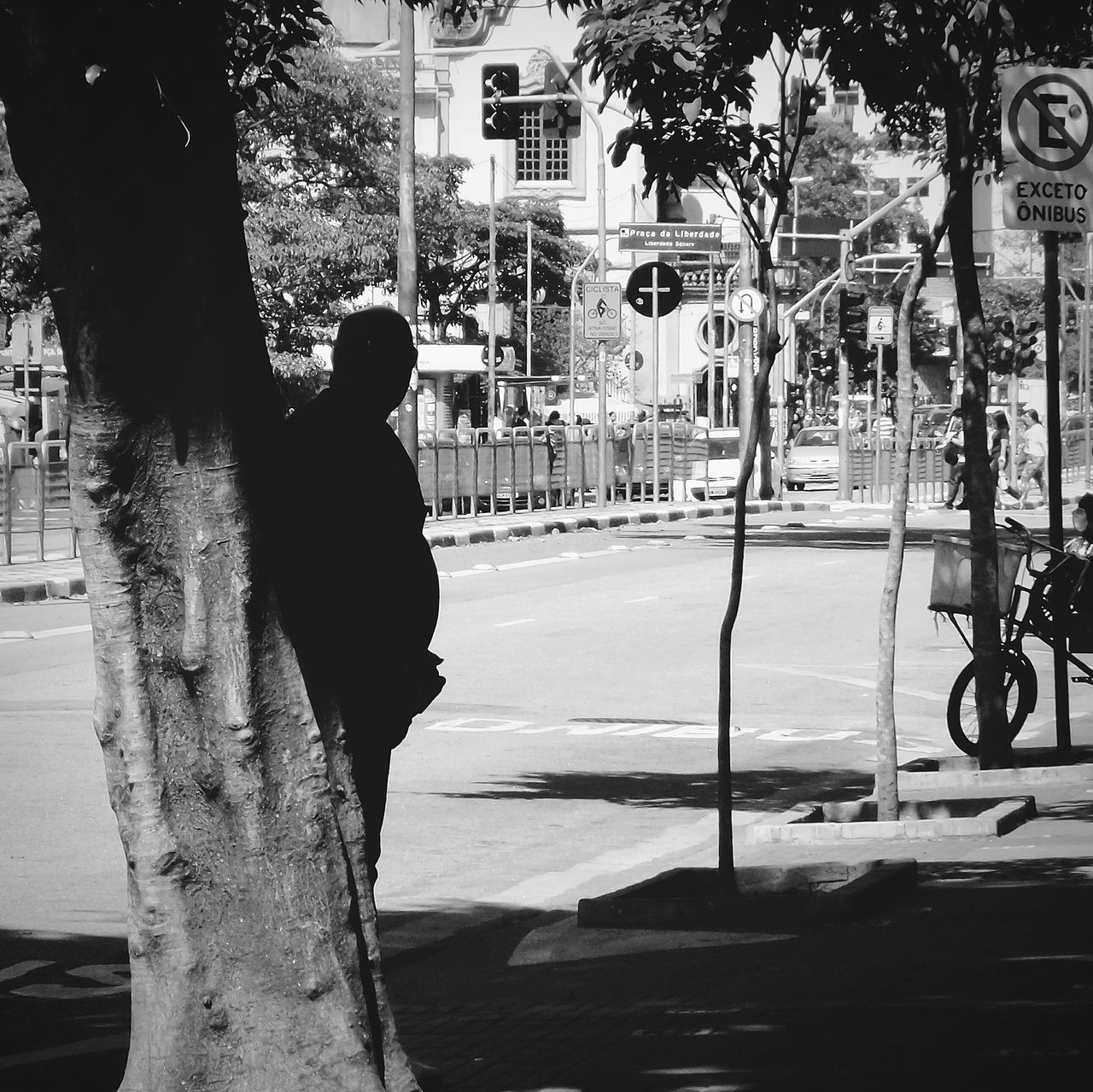 street, building exterior, architecture, built structure, city, walking, road, tree, lifestyles, sidewalk, city life, full length, transportation, outdoors, rear view, leisure activity, day, shadow