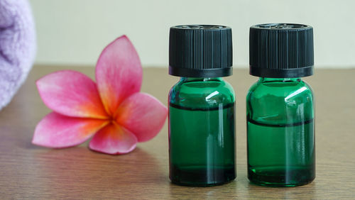 Close-up of pink bottles on table