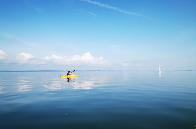 Man in sea against sky