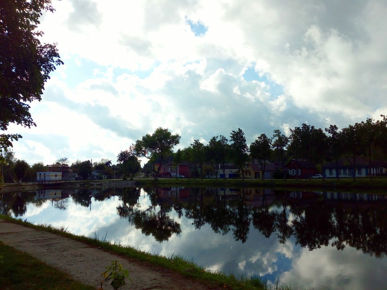 water, sky, cloud - sky, tree, reflection, architecture, river, built structure, building exterior, outdoors, day, nature, no people, riverbank, scenics, beauty in nature