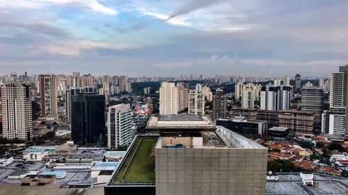 Cityscape against cloudy sky