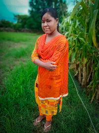 Portrait of girl standing on field