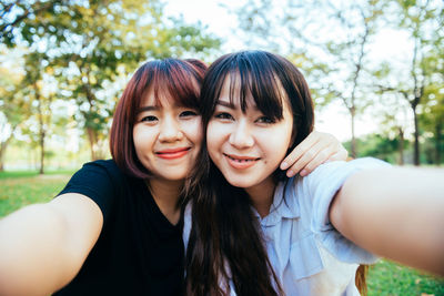 Portrait of smiling young woman using smart phone