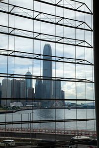 Buildings in city seen through glass window