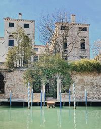 Building by swimming pool against sky