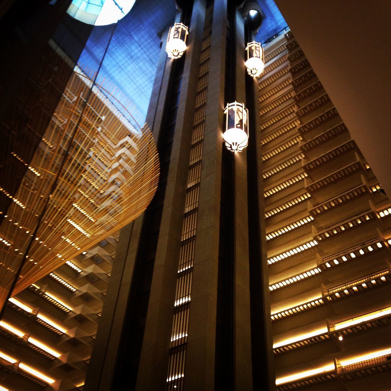 LOW ANGLE VIEW OF ILLUMINATED MODERN BUILDING