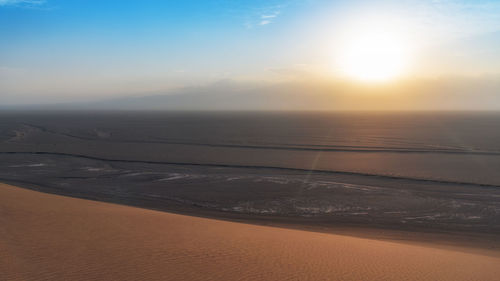 Scenic view of beach against sky during sunset