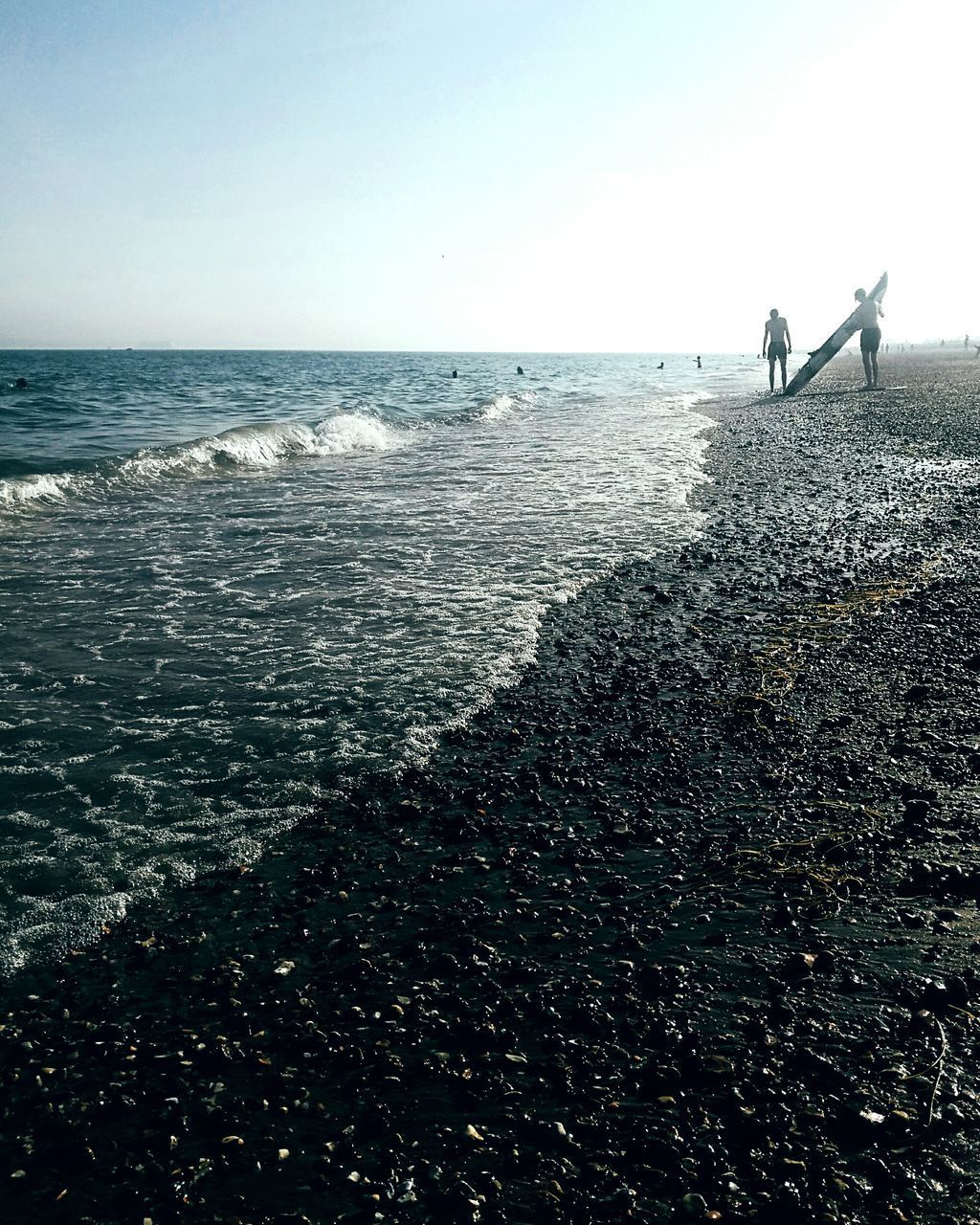 PEOPLE AT BEACH AGAINST CLEAR SKY