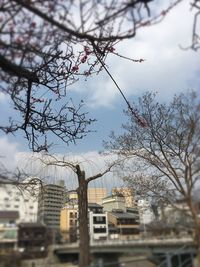 View of cityscape against cloudy sky