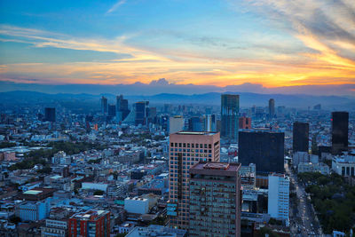 High angle view of buildings against sky during sunset