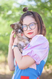 Portrait of woman holding cat