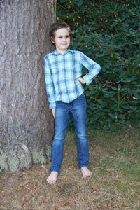 Portrait of smiling boy standing on grass