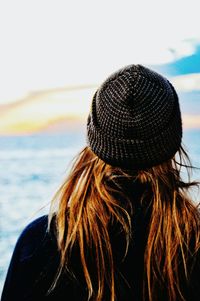 Rear view of woman standing on beach