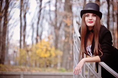 Portrait of beautiful young woman in park during autumn