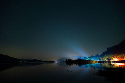 Scenic view of lake against sky at night