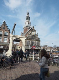 People walking near church at alkmaar cheese market