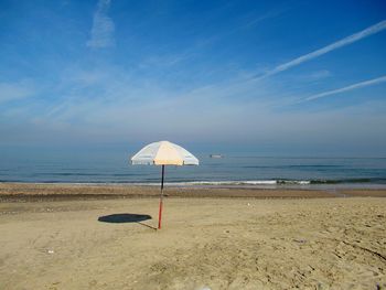 Lifeguard hut on beach against sky