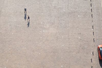 High angle view of people walking on footpath