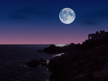 Scenic view of sea against sky at night