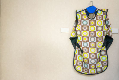 Patterned apron hanging on wall