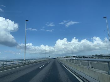 Road by highway against sky